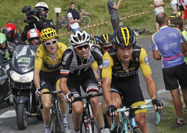 Stage winner Slovenia's Primoz Roglic is followed by Netherlands' Tom Dumoulin, left, and Britain's Geraint Thomas, wearing the overall leader's yellow jersey, as they climb Col d'Aubisque pass during the nineteenth stage of the Tour de France . Picture: AP/Christophe Ena.