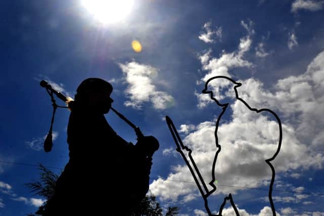Piper Rachael Blueman plays at the unveiling of the Tommy tribute.
