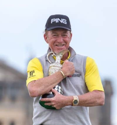 Spain's Miguel Angel Jimenez celebrates with the trophy after winning the Senior Open at Old Course St Andrews.