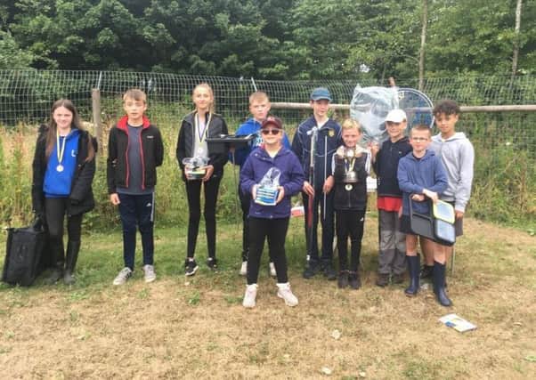 Yarnbury AC winners show off the Old Ball Cup and prizes donated by local businesses, proof that their future is in good hands.