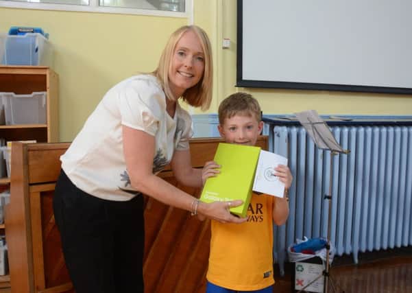 Sarah Joseph, Manning Stainton Horsforth branch manager, with Leo Harrington, pupil of Featherbank Primary School