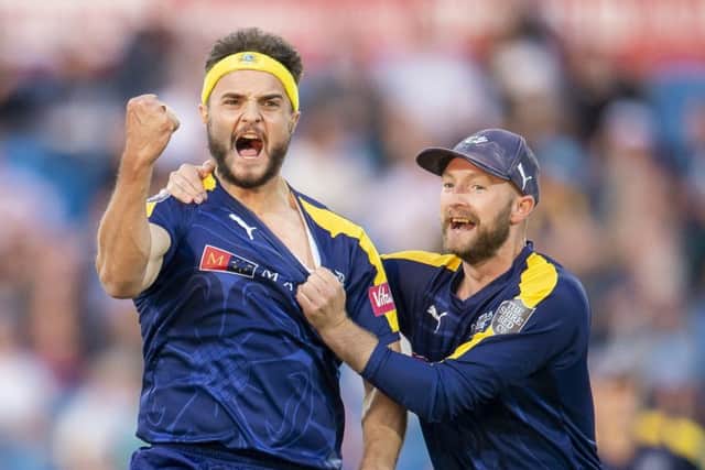 Yorkshires Jack Brooks celebrates with Adam Lyth after dismissing Leicestershires Neil Dexter at Emerald Headingley last night (Picture: Allan McKenzie/SWpix.com).