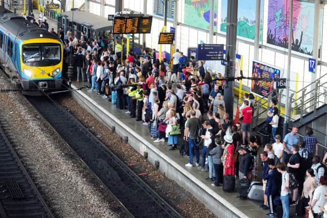 Commuters awaiting a Manchester-bound train at Leeds Station.