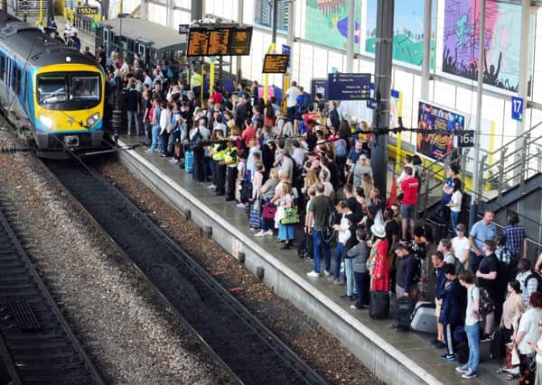 Commuters awaiting a Manchester-bound train at Leeds Station.