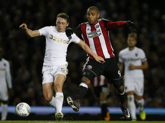 Matthew Pennington battles with Sheffield United's Leon Clarke during his loan at Leeds United last season.