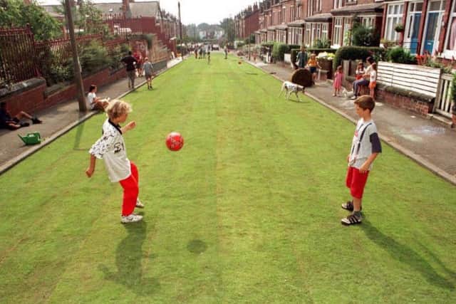 Liall Bolens, 12 yrs (l) and Chris McQuade, 11 yrs (r) play football on Methley Terrace, Leeds, after Transport 2000 and the local residents turfed the street at the Launch of their "Streets For People" campaign,  designed to encourage people to reduce the ammount of trafffic in their neighbourhoods. Photo by Paul Barker/PA. See PA Story TRANSPORT Streets.