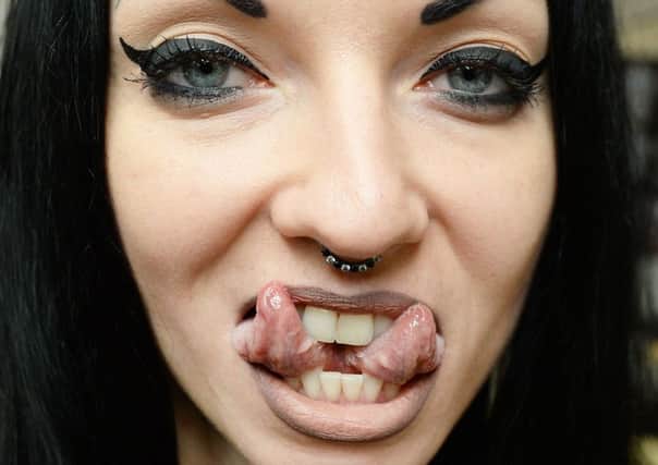 Aneta Von Cyborg showing off her split tongue at the Tattoo Collective convention in London. PIC: PA