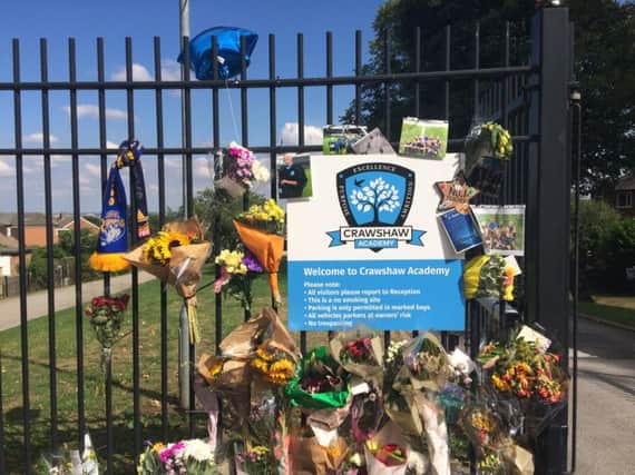 Flowers and tributes at the gates of Crawshaw Academy, Pudsey.