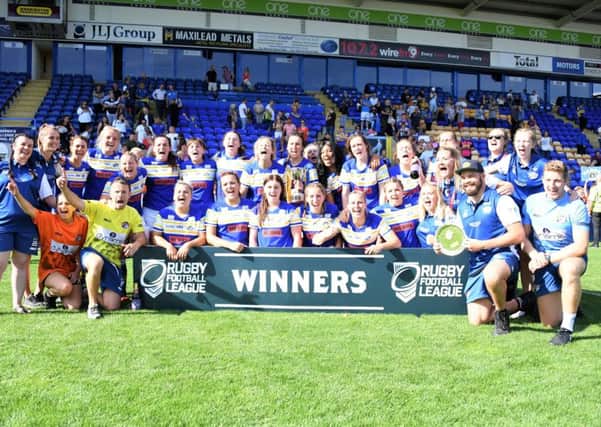 Leeds Rhinos women's team celebrate with the Challenge Cup.