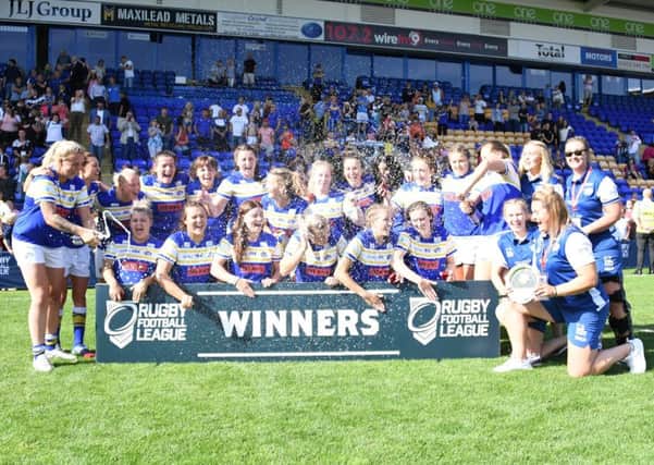 Leeds Rhinos women celebrate their Challenge Cup final victory over Castleford Tigers.