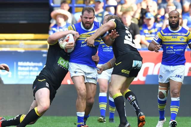 Leeds Rhinos' Adam Cuthbertson is tackled during the Challenge Cup semi-final against Warrington.