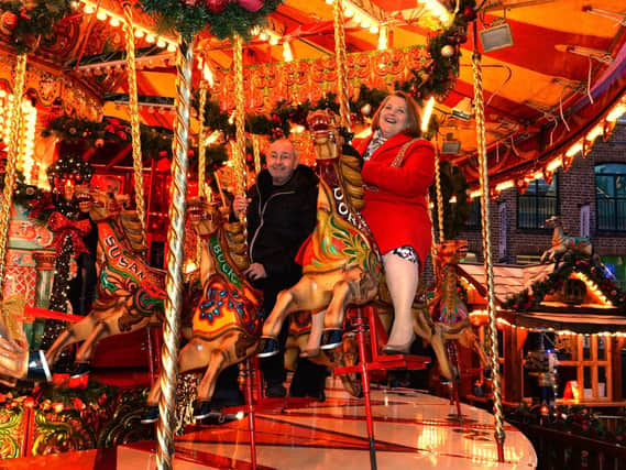 The Lord Mayor of Leeds, Councillor Jane Dowson , enjoying the merry go round with Kurt Stroscher at the Leeds German Christmas Market.