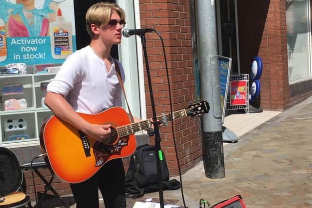 PITCH: Luke Flear busking outside WH Smith in Leeds city centre.