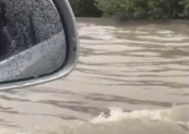 In this image from video, flash floods send a torrent of water down a street in Aubagne, France on Thursday, Aug. 9, 2018. Hundreds of rescuers backed by helicopters evacuated about 1,600 people, most of them campers, in three regions of southern France where heavy rain caused flash flooding and transformed rivers and streams into torrents, the interior minister said Thursday. (Stephane Decoux via AP)