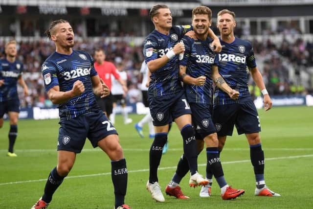 Leeds United's players celebrate after opening the scoring at Pride Park,