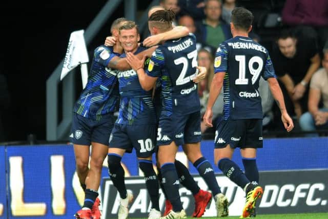 Leeds United's players celebrate Gjanni Alioski's goal at Derby.