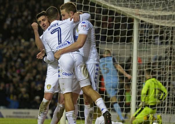 In at the double: Chris Wood celebrates his second goal with Pablo Hernandez and Kemar Roofe.