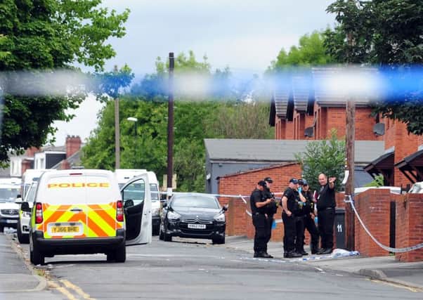 Police at the scene in Reginald Street, Chapeltown, where Christopher Lewis was fatally shot.