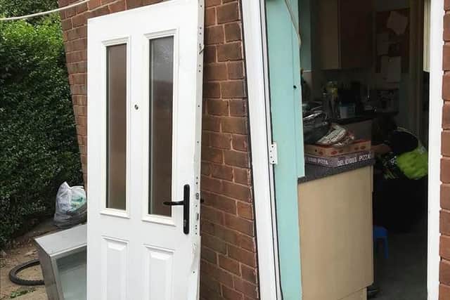 A door off its hinges in Latchmere Drive