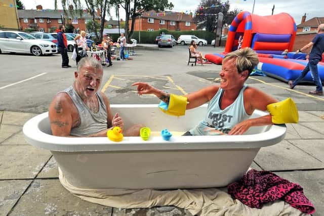 Amanda Homer and Chris Packer in a bath of custard as part of a day of activities at The Orchard pub on Dib Lane, Oakwood to raise funds for the children's unit for cystic fibrosis at St James's Hospital. Picture by Tony Johnson.