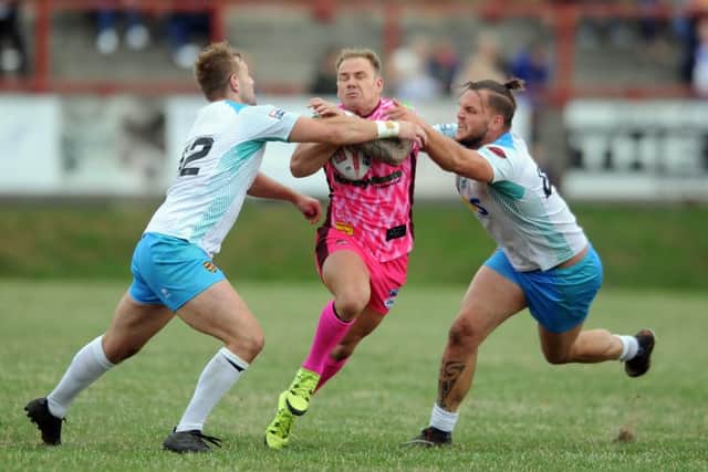 Rams' Tobias Richardson and Kyle Trout combine to tackle Bulldogs playmaker Dom Brambani. PIC: Tony Johnson
