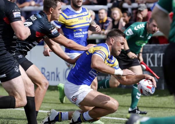 Joel Moon bursts through for his third try for Leeds at London.