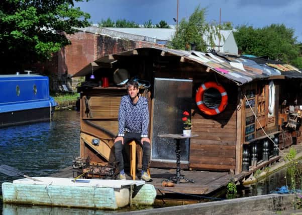Ben Cummins on board his floating shed at Oddy Locks  on the Leeds Liverpool Canal in Leeds.