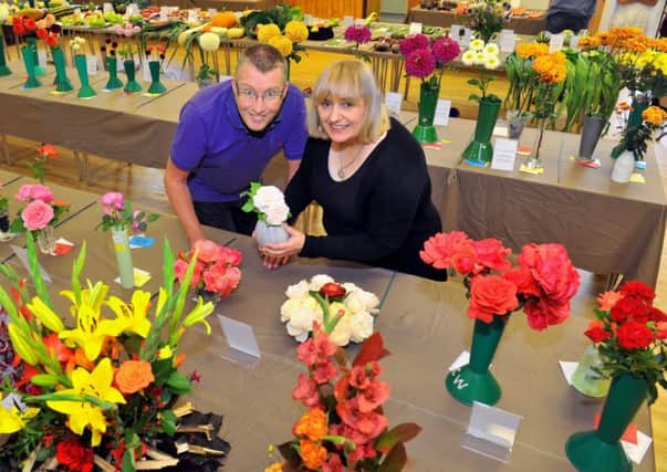 Aberford Horticultural Society committee members Andrew Burrell  and Theresa Tweedy looking at the floral enties in the 54th Aberford Show.