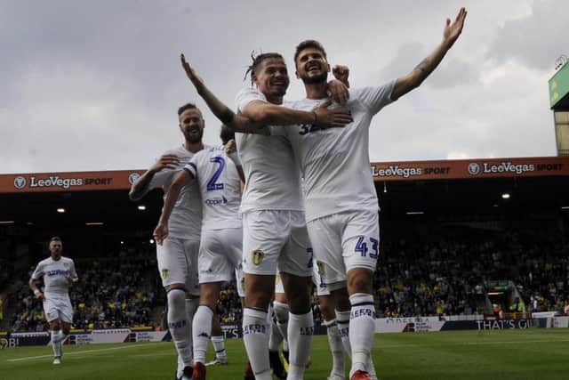 Kalvin Phillips and Mateusz Klich celebrate the opening goal at Norwich.