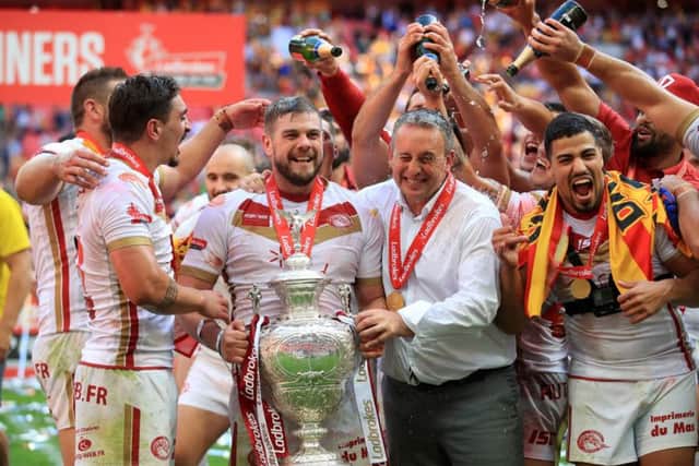 Catalan Dragons' Remi Casty (centre left) and head coach Steve McNamara celebrate with the Challenge Cup.