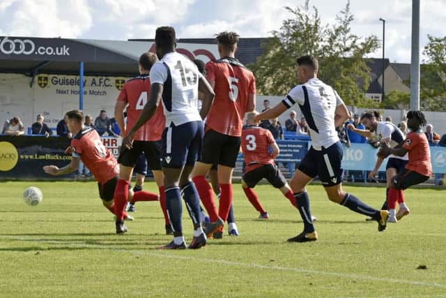 Alex Purver, right, scores the equaliser for Guiseley against Nuneaton.