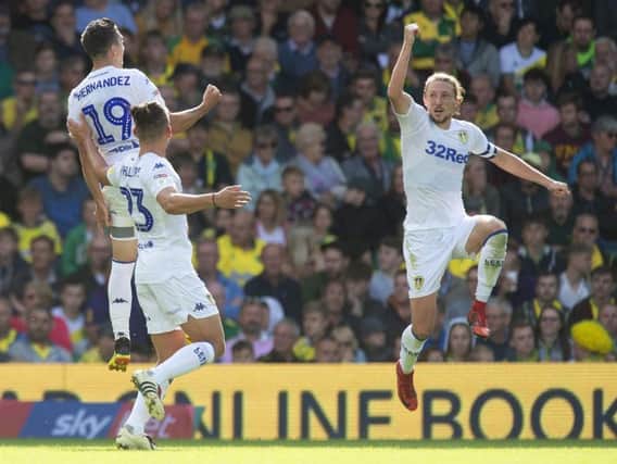 FLYING HIGH: Pablo Hernandez celebrates his stunning strike with midfielder Kalvin Philiips and birthday boy captain Luke Ayling as Leeds United move top of the division with a 3-0 win at Norwich City.