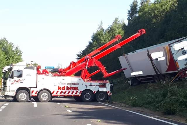 The lorry is lifted from the embankment. PIC: Highways England
