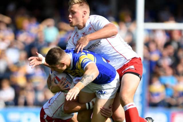 Liam Sutcliffe is wrapped up by the Hull KR defence. PIC: James Hardisty