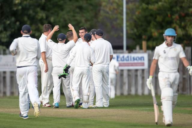 Otley's Sam Fox (facing) celebrates another wicket