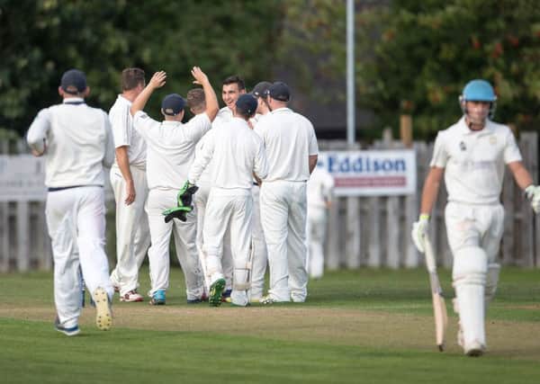 Otley's Sam Fox (facing) celebrates another wicket