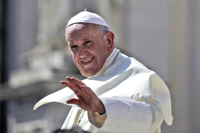 Pope Francis waves as he leaves at the end of his weekly general audience, St. Peter's Square, at the Vatican. PIC: AP