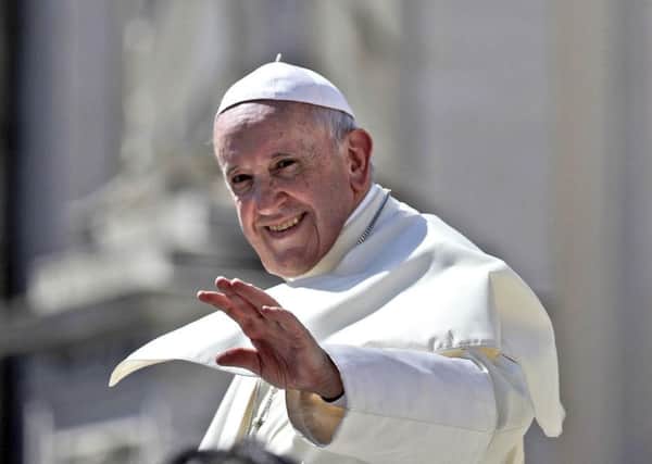 Pope Francis waves as he leaves at the end of his weekly general audience, St. Peter's Square, at the Vatican. PIC: AP