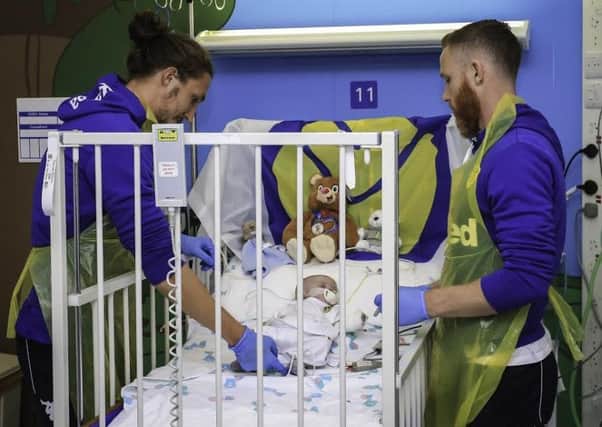 Leeds United's Luke Ayling, left, and Adam Forshaw  pictured during a visit to Leeds Congenital Heart Unit, Leeds General Infirmary.