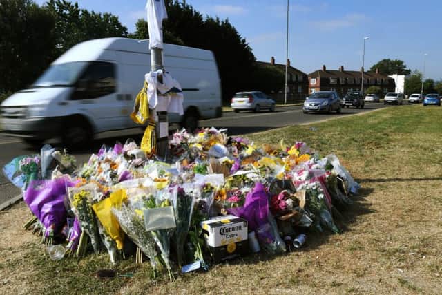 Floral tributes at the car crash site in Broadway, Horsforth.