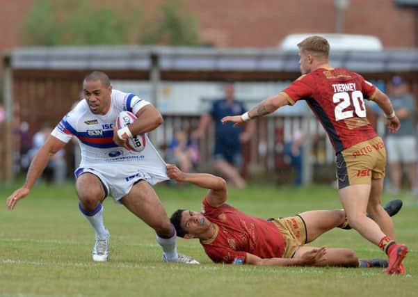 Adam Cuthbertson's Dream Team members, Catalans Dragons full-back Tony Gigot (tackling) and Wakefield centre Bill Tupou.
 Picture: Bruce Rollinson.
