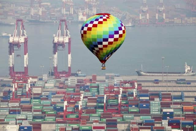 A hot-air balloon flies over a container port in Qingdao in east China's Shandong province