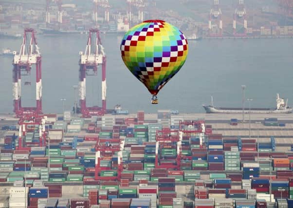 A hot-air balloon flies over a container port in Qingdao in east China's Shandong province