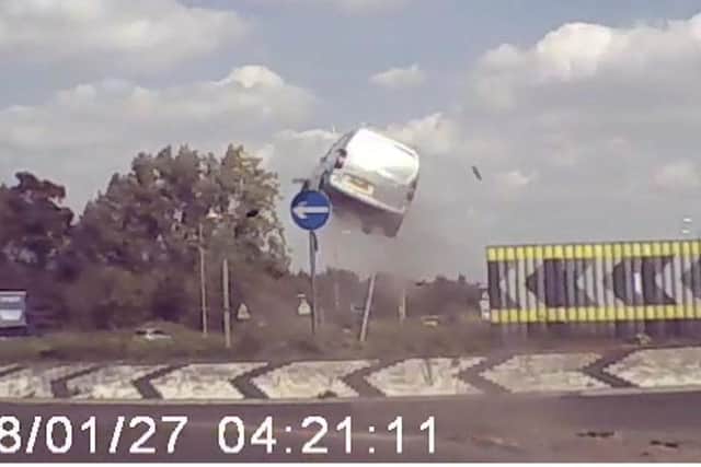 The crazy moment the van flies over the roundabout. Photo: SWNS