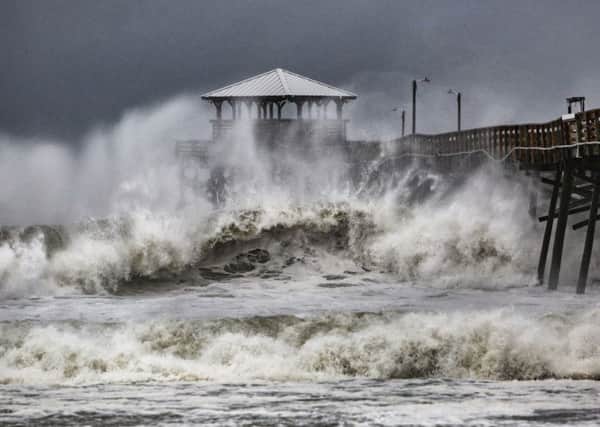 Waves slam the Oceana Pier & Pier House Restaurant in Atlantic Beach, North Carolina.