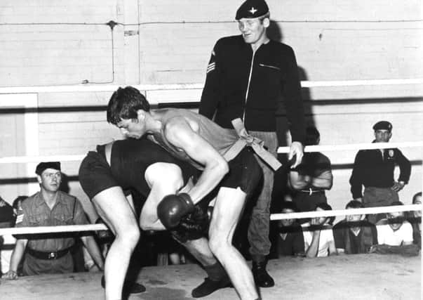 Leeds, Pudsey, 15th July 1973

Sargeant Richard Dunn, a parachute regiment contender for the British heavyweight boxing championship, supervises a bout in the ring at Pudsey.

BOXING FACTS:

30th September 1975

Richard Dunn beat Bunny Johnson on points over 15 rounds to win the British and Commonwealth heavyweight titles.