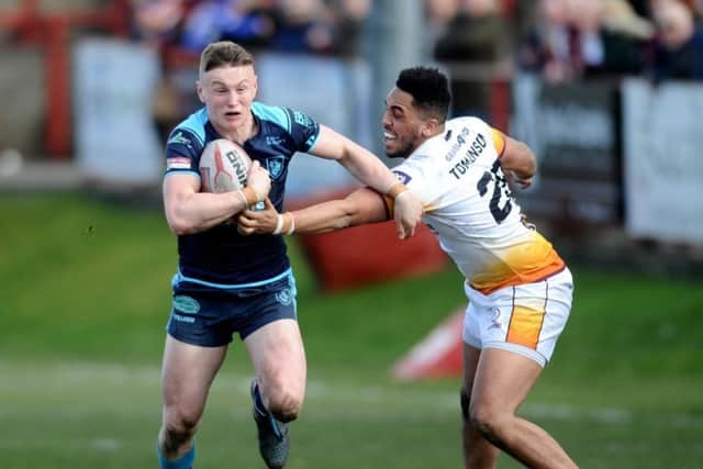 Betfred Championship.Batley Bulldogs v Featherstone Rovers.Rovers Harry Newman gets away from Batley's Keenan Tomlinson.24th March 2018.Picture Jonathan Gawthorpe