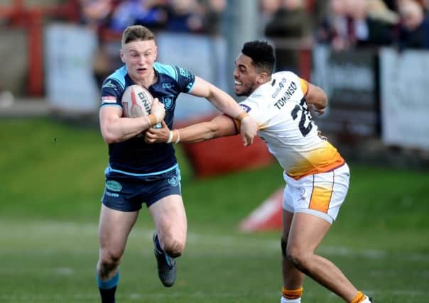 Betfred Championship.Batley Bulldogs v Featherstone Rovers.Rovers Harry Newman gets away from Batley's Keenan Tomlinson.24th March 2018.Picture Jonathan Gawthorpe