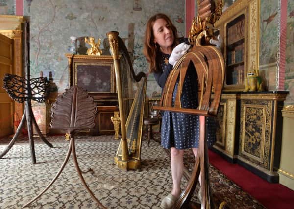 Leila Prescott, curator at Temple Newsham, with 'Solar Flare' by Paul Ferguson  - one of the seven specially commisioned music stands on display in the house.  The stands are part of an exhibition by the Master Carvers' Association.   17 September 2018.  Picture Bruce Rollinson