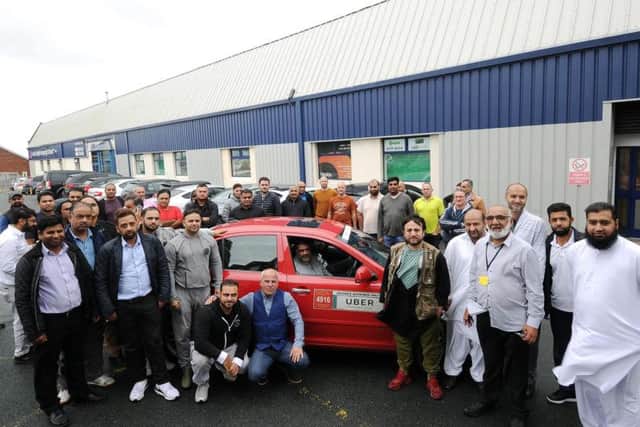 Protesting Uber drivers gathered outside the company's offices in Leeds.